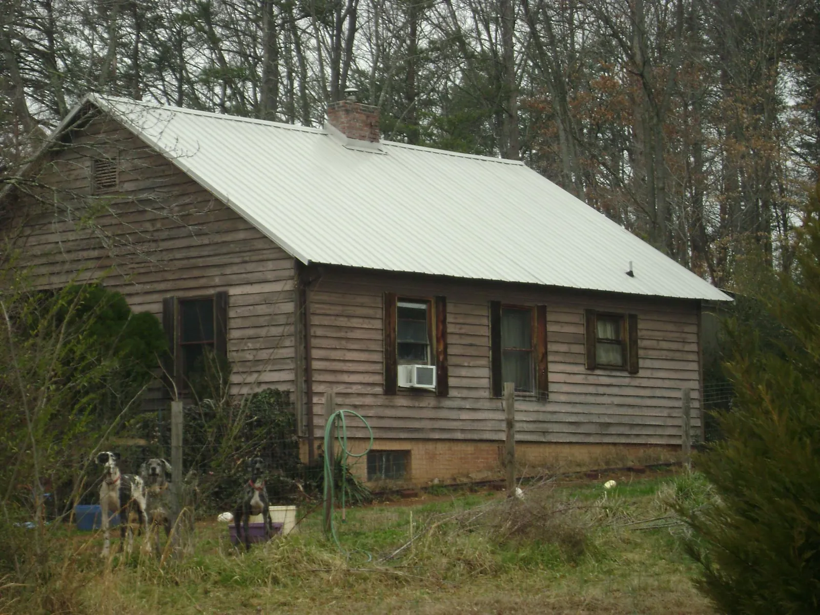 White metal roof on an old wood sided farmhouse, from a Metal Roof Installation job in Inchelium